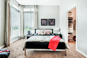 Denver apartment for rent - A bedroom with a bed, nightstands, and a window with curtains.