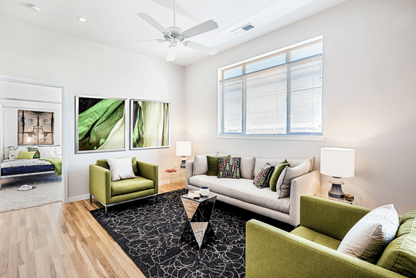 Denver apartment for rent - A living room with a green couch and a white couch.