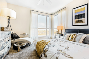 Denver apartment for rent - A bedroom with a large bed and a view of the ocean.