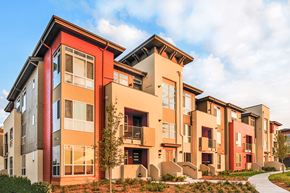 Denver apartment for rent - A modern apartment building with red and beige facades.