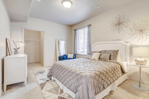 Murray apartment for rent - Virtually staged bedroom with carpet, accent run, walk in closet, window with blinds and curtains and white dresser with blue chair