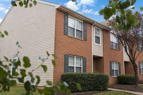 Stafford apartment for rent - A red brick apartment building with green shutters on the windows.