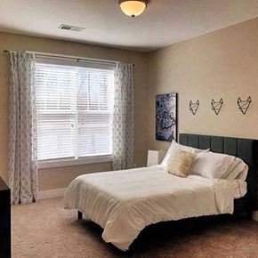 Raleigh-Durham apartment for rent - A bedroom with a bed, pillows, and a window with curtains at Foxwood Apartments, Raleigh-Durham, NC, 27616