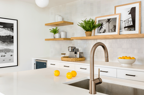 Jacksonville apartment for rent - a kitchen with white cabinets and a stainless steel sink
