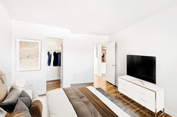 Denver apartment for rent - A living room with a couch, a television, and a painting on the wall.