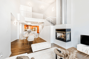 Denver apartment for rent - A modern living room with a fireplace and a staircase.