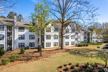 Douglasville apartment for rent - A large white building with a tree in front of it.