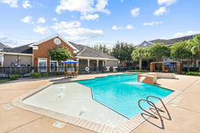 Houston apartment for rent - A swimming pool in a sunny outdoor setting.