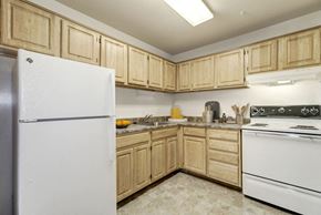 Waldorf apartment for rent - a kitchen with a white refrigerator freezer next to a stove top oven