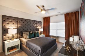 Charlotte apartment for rent - a bedroom with a large bed and a ceiling fan
