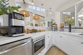 Davie apartment for rent - clubhouse kitchen with white cabinets and stainless steel appliances.