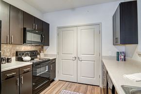 Lawrenceville apartment for rent - Kitchen with dark wood cabinets and hardwood floor
