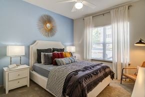 Lawrenceville apartment for rent - a bedroom with a bed and a ceiling fan