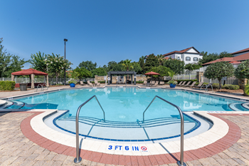 Resort-style swimming pool with jacuzzi & cabanas