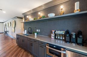 Seymour apartment for rent - A kitchen with dark wood cabinets and a stainless steel dishwasher.