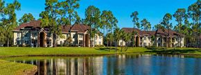 Greenacres apartment for rent - Waterfront View with Palm Trees and Building Exteriors