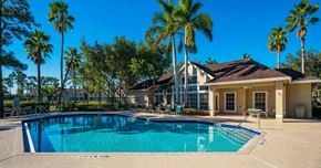 Greenacres apartment for rent - Swimming Pool and Sun Deck with Lounge Chairs with Trees and Building Exteriors in the Background