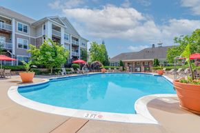 Frederick apartment for rent - A large swimming pool in front of a building with a sign that says 3 FT.
