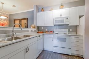 Frederick apartment for rent - A kitchen with white cabinets and appliances.