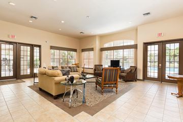 Bradenton apartment for rent - A living room with a glass table and chairs.