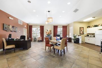 Vero Beach apartment for rent - A kitchen with a table and chairs in the middle of the room.
