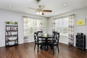 Sanford apartment for rent - Clubhouse interior with hardwood style flooring, table, and chairs in the background.