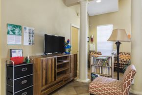 Vero Beach apartment for rent - Clubhouse Seating Area in Front of Entertainment Center with TV Next to Bookshelf