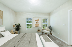 Kennesaw apartment for rent - A bedroom with a large bed and a chair.