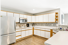 Columbia apartment for rent - A kitchen with a refrigerator, microwave, and wooden cabinets.