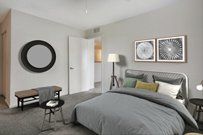 Jacksonville apartment for rent - Virtually staged bedroom with wall mounted mirror, night stands, desk lamps, bed, bench, and wall art