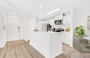Charlotte apartment for rent - A kitchen with white cabinets and a wooden floor. at The Grayson Apartment Homes, Charlotte