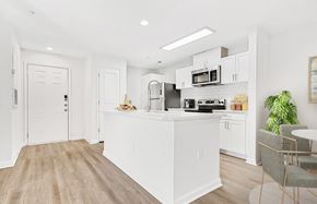 Charlotte apartment for rent - A kitchen with white cabinets and a wooden floor. at The Grayson Apartment Homes, Charlotte