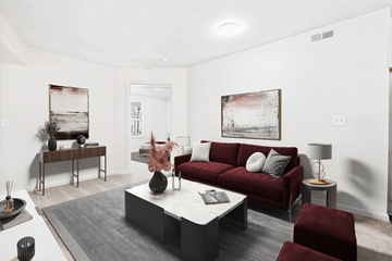 High Point apartment for rent - A living room with a red couch and a grey rug.