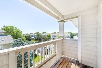 Covered balcony with overhead pergola and railing