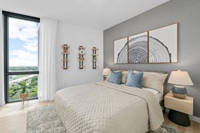 West Palm Beach apartment for rent - A bedroom with a large bed and a view of the ocean.