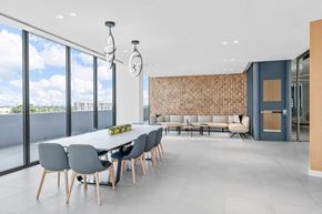 West Palm Beach apartment for rent - A modern dining room with a long table and chairs.