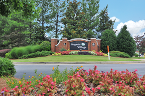 Lawrenceville apartment for rent - Community sign in the middle of a flower bed.