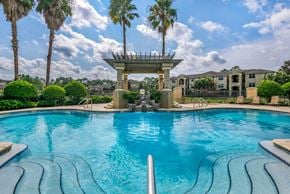 Jacksonville apartment for rent - Resort style swimming pool with sundeck and lounge seating surrounded by native landscaping