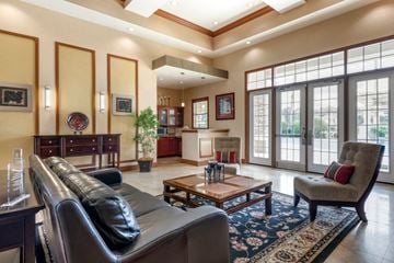 Jacksonville apartment for rent - A living room with a black leather couch and a wooden coffee table.