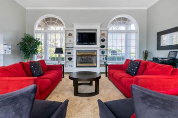 Orlando apartment for rent - A living room with red couches and a fireplace.