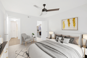 Jacksonville apartment for rent - a bedroom with a large bed and a ceiling fan