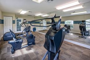 Jacksonville apartment for rent - Fitness center with cardio equipment and large mirrors