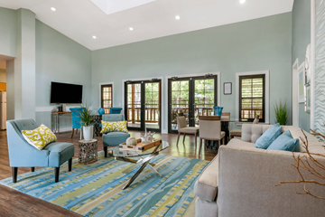 Orlando apartment for rent - A living room with a blue rug and a grey couch.