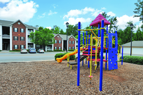 Kennesaw apartment for rent - A playground with a blue and yellow slide and a red and yellow tower.