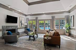 Lawrenceville apartment for rent - Durant at Sugarloaf Apartments clubhouse featuring seating, tv and a view of the community pool
