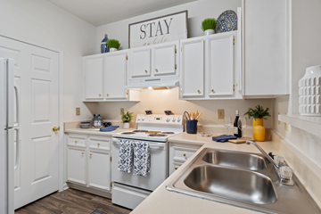 Lawrenceville apartment for rent - A kitchen with white cabinets and a stainless steel sink.