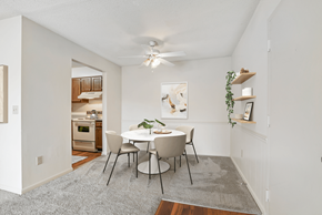 High Point apartment for rent - a dining area with a white table and chairs and a ceiling fan at Eastchester Ridge Apartments, High Point, North Carolina