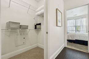Orlando apartment for rent - A white bedroom with a bed in the other room.