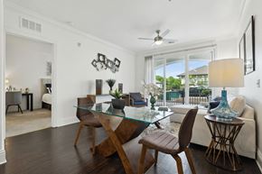 Orlando apartment for rent - A modern dining room with a glass table and chairs.