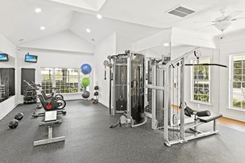 A spacious home gym with a variety of exercise equipment.
